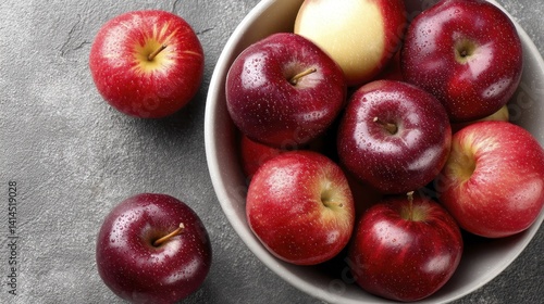 A bowl overflowing with various kinds of colorful dessert apples - apples crisp fuji sweet