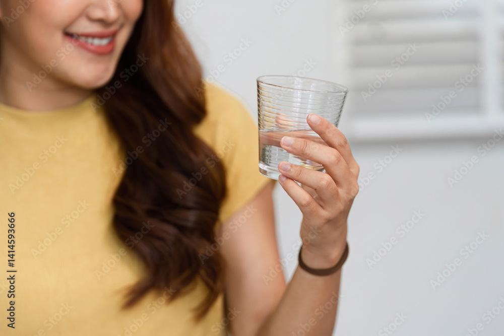 Morning Routine and Smiles. A woman cheerfully enjoying a refreshing drink as part of her morning routine. Morning Routine and Smiles. A woman cheerfully enjoying a refreshing drink as part of her morning routine.