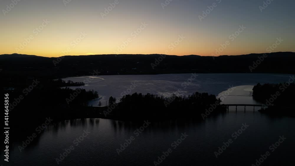 Landscape of a frozen winter lake at sunset Landscape of a frozen winter lake at sunset