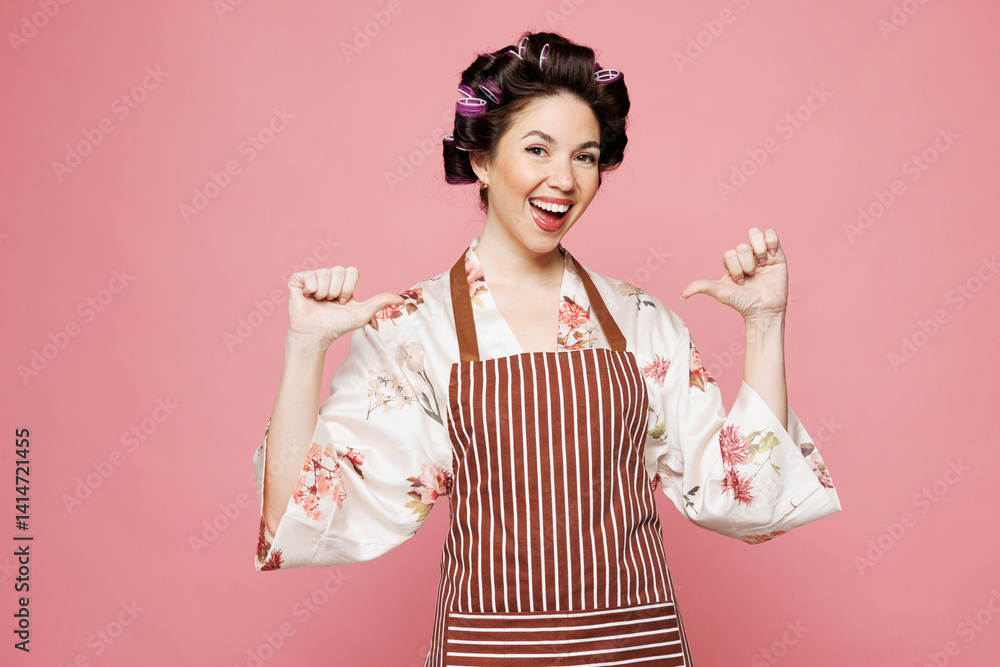 Young happy smiling housewife housekeeper chef cook baker woman wear brown apron point thumb finger on herself brag isolated on pastel light pink color background studio portrait Cooking food concept Young happy smiling housewife housekeeper chef cook baker woman wear brown apron point thumb finger on herself brag isolated on pastel light pink color background studio portrait Cooking food concept