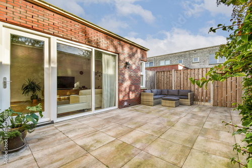 Wallpaper Mural Bright and airy modern patio featuring a cozy seating area surrounded by greenery. Ideal for relaxation and entertaining outdoors. Torontodigital.ca