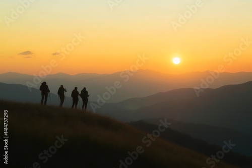 Four hikers standing on a grassy mountain ridge  enjoying a breathtaking view of the rising sun over layers of mountains