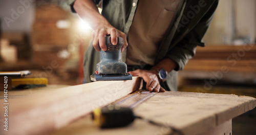 Fotografija Person, hands and carpenter with sander at workshop for polish, craft or lumber project
