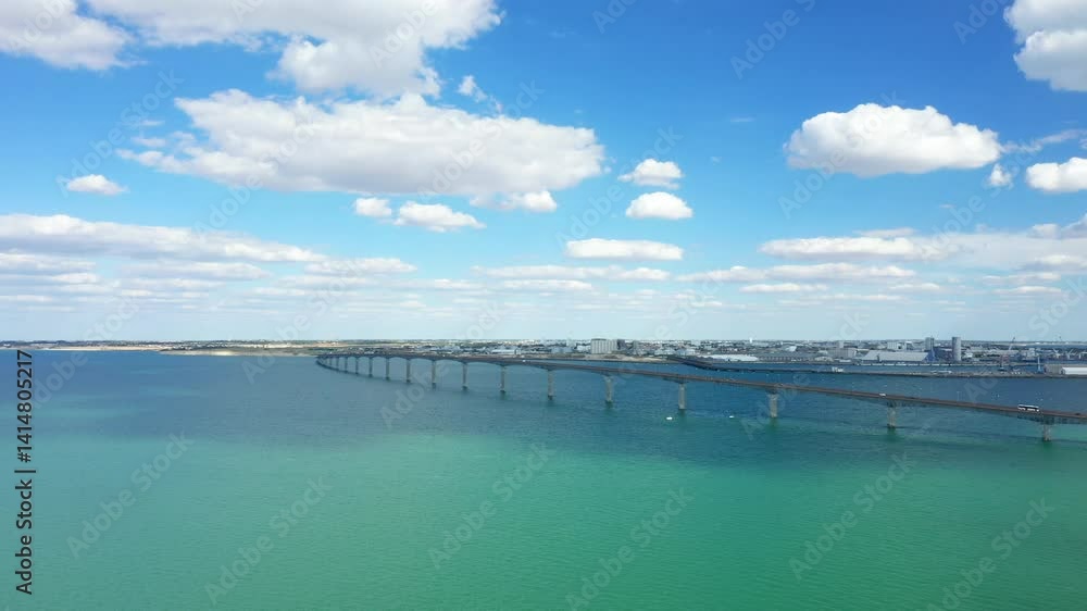 The long bridge of the ile de Re over the sea in Europe, in France, in New Aquitaine, in Charente Maritime, in summer, on a sunny day. The long bridge of the ile de Re over the sea in Europe, in France, in New Aquitaine, in Charente Maritime, in summer, on a sunny day.
