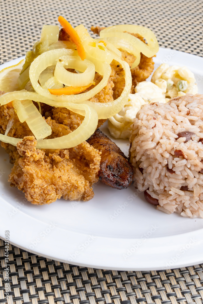 Tender Fried Groupers Served with Pickled Onions and Rice and Beans