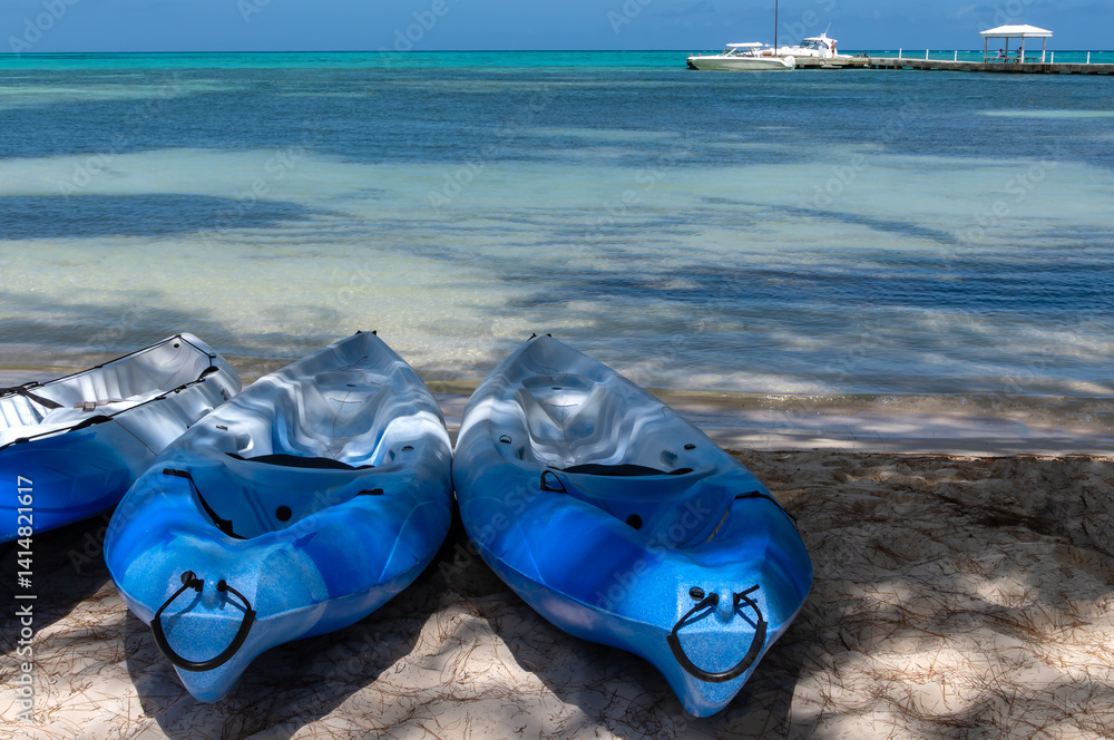 Row of Blue Kayaks on a Sandy Beach in Rum Point, Grand Cayman Island