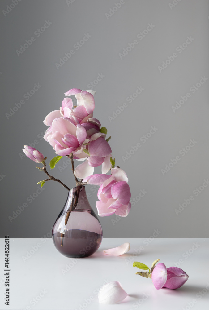 magnolia wreath in glass vase on wall background