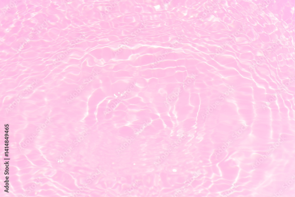 Fototapeta premium Pink water bubbles on the surface ripples. Defocus blurred transparent pink colored clear calm water surface texture with splash and bubbles. Water waves with shining pattern texture background