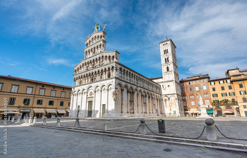 Panoramic view of Chiesa di San Michele in Foro in the historic center of Lucca Italy on a sunny summer day with clear blue sky and warm light on the ancient architecture