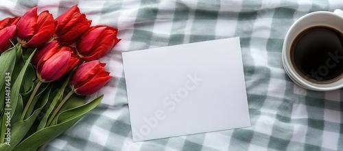 Obraz na płótnie A blank card rests next to vibrant tulips and a warm cup of coffee atop a bed with a mint green backdrop. w salonie