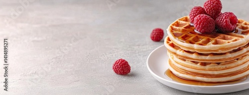 Obraz na płótnie Indulge in a stack of golden waffles drizzled with maple syrup and adorned with fresh raspberries, perfect for any breakfast occasion w salonie