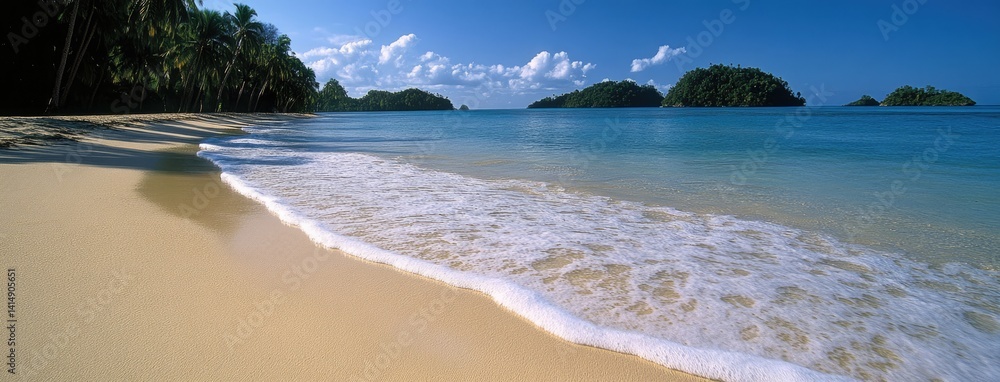 Relaxing beach with turquoise waters and distant islands creates a serene getaway for vacationers enjoying sunny skies and gentle waves