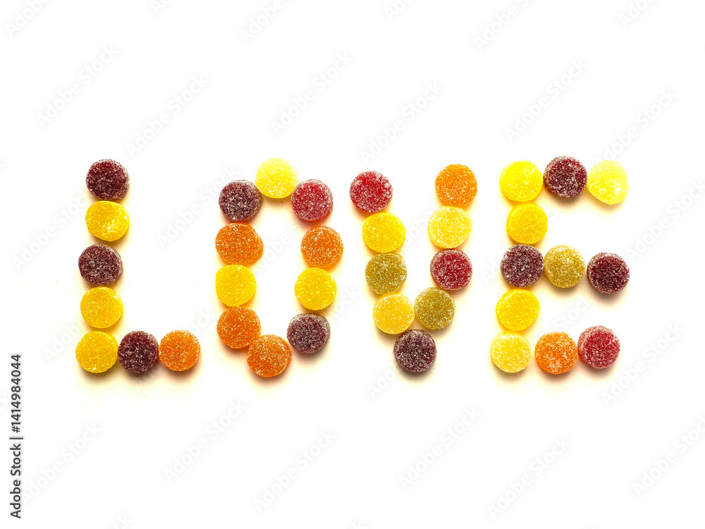 Sign love made of round sugar sweets on white background.