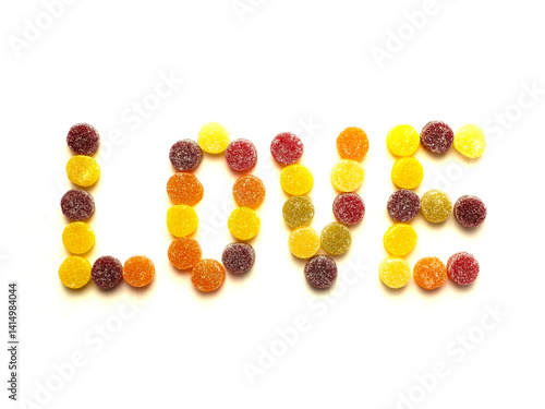 Obraz na płótnie Sign love made of round sugar sweets on white background. w salonie