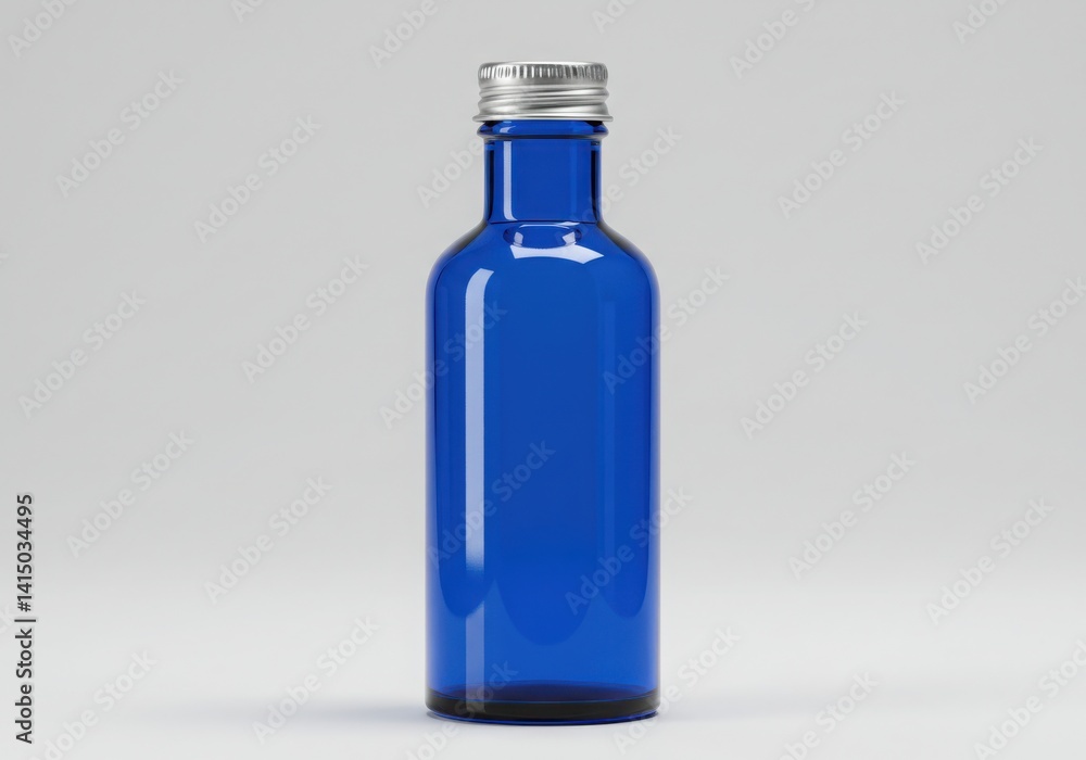A single blue glass bottle with a silver cap isoleted on white background A single blue glass bottle with a silver cap isoleted on white background