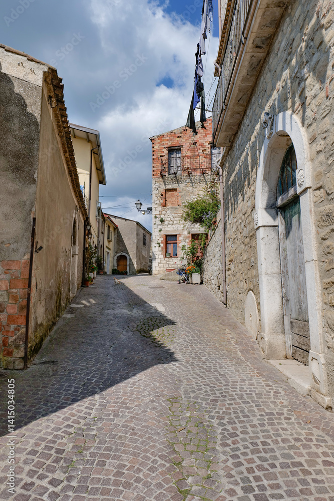 A narrow street between the old houses of San Giorgio la Molara in Campania, Italy.
