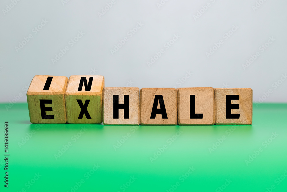flip wooden blocks with inhale and exhale words isolated on white and green background flip wooden blocks with inhale and exhale words isolated on white and green background