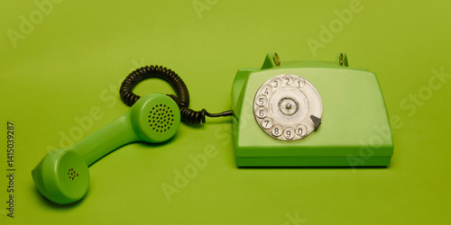 Canvastavla Classic green rotary phone in bold minimal composition on matching green background