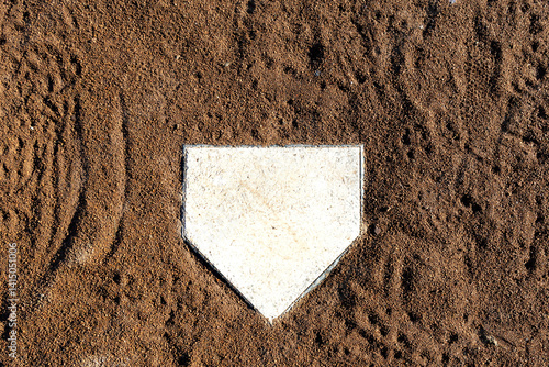 home plate from above, cleat marked clay soil around plate