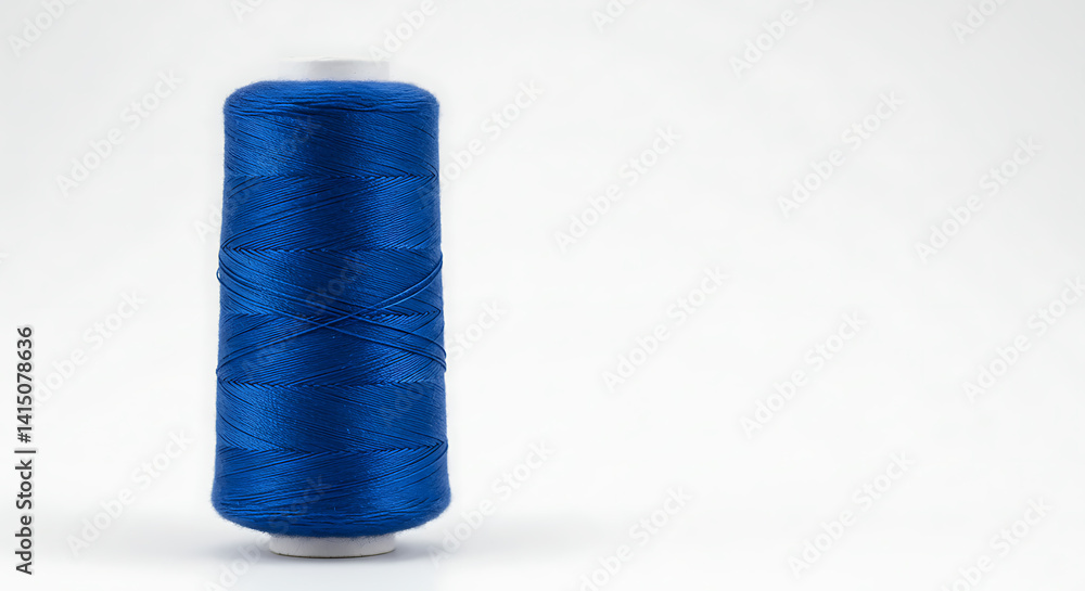 Blue Sewing Thread Spool Standing Upright on White Background Blue Sewing Thread Spool Standing Upright on White Background
