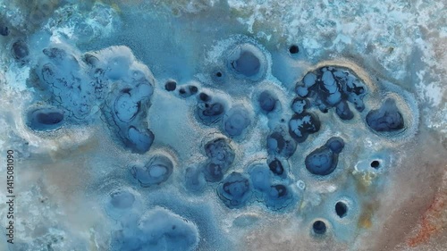 Aerial shot of fumaroles and active boiling mud pits in Hverir, Iceland, illustrating geothermal energy release and sulfur deposits.