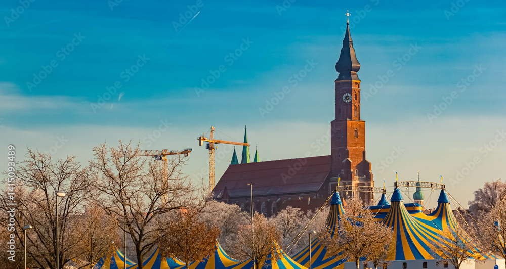 A church and yellow blue circus tents on a sunny winter day at Straubing, Straubing-Bogen, Bavaria, Germany