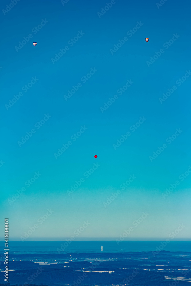 Alpine winter view with many hot air balloons at Bad Kohlgrub, Garmisch-Partenkirchen, Bavaria, Germany Alpine winter view with many hot air balloons at Bad Kohlgrub, Garmisch-Partenkirchen, Bavaria, Germany