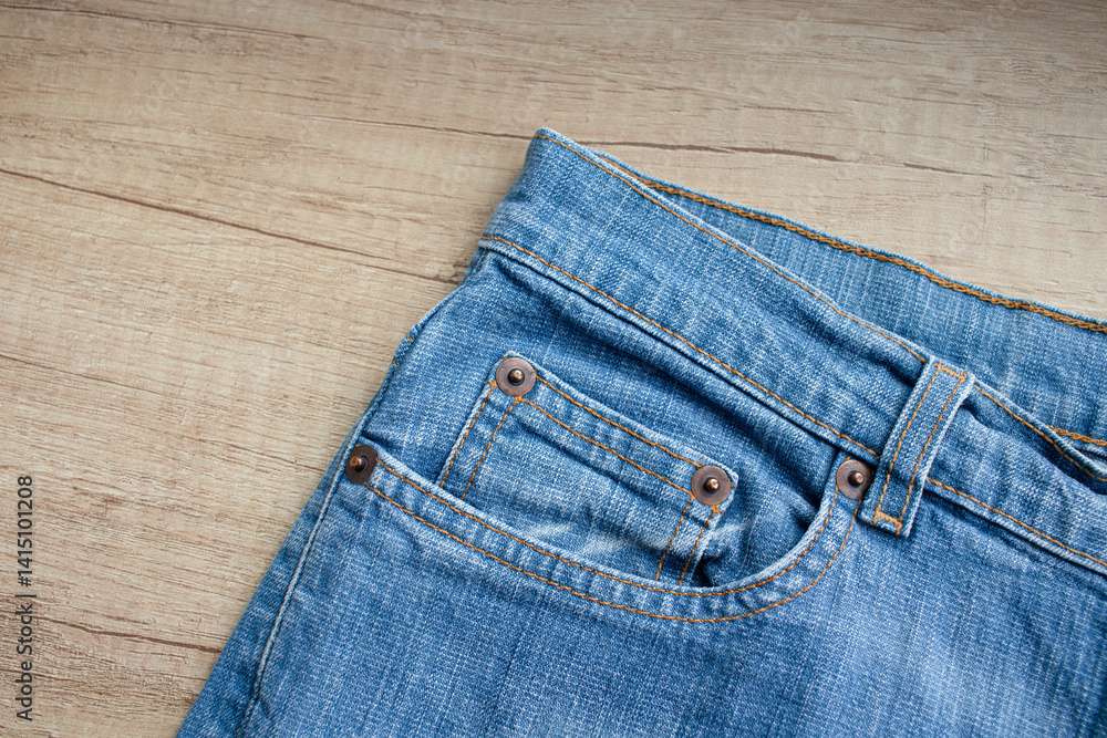 Close-up of blue denim jeans with pocket. Background denim texture Close-up of blue denim jeans with pocket. Background denim texture