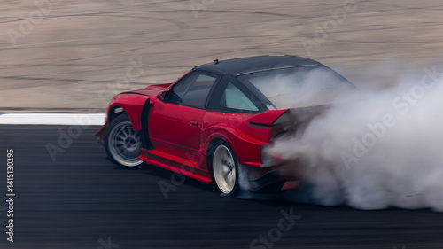 Obraz na płótnie Car drifting on asphalt race track with lots of smoke from burning tires, Professional driver drift car on asphalt race track, Car motion blurred, Motorsport car drift. w salonie
