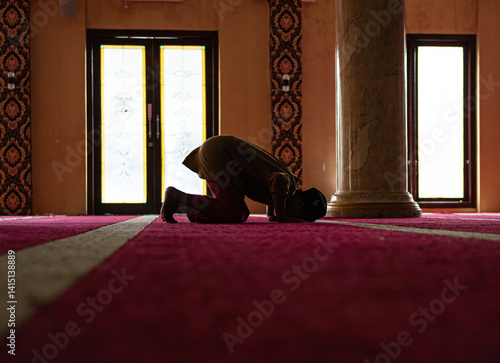 Tableau sur toile Silhouette of a person prostrating in the mosque.