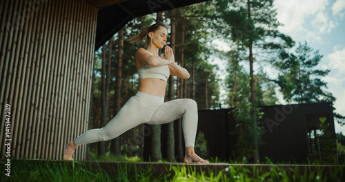 Konstfotografi In a Forest Meadow with Wooden Cottage Houses, a Female Yoga Practitioner Moves Through Her Asanas, Enjoying the Stillness of Natural World