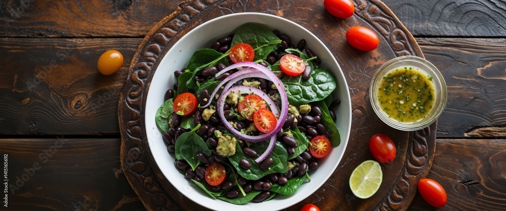 there is a bowl of salad with tomatoes and black beans