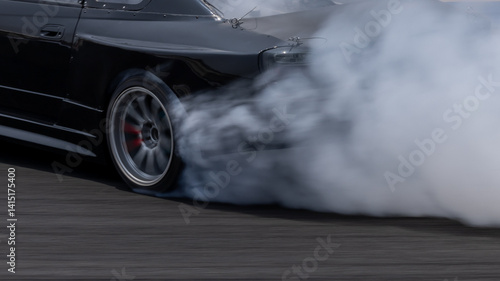 Obraz na płótnie Car drifting on asphalt race track with lots of smoke from burning tires, Professional driver drift car on asphalt race track, Car motion blurred, Motorsport car drift. w salonie