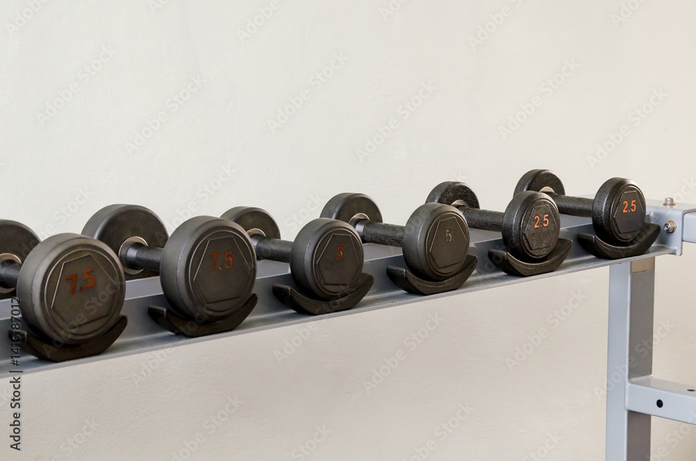Dumbbells on Rack in Gym Equipment Storage Room Dumbbells on Rack in Gym Equipment Storage Room