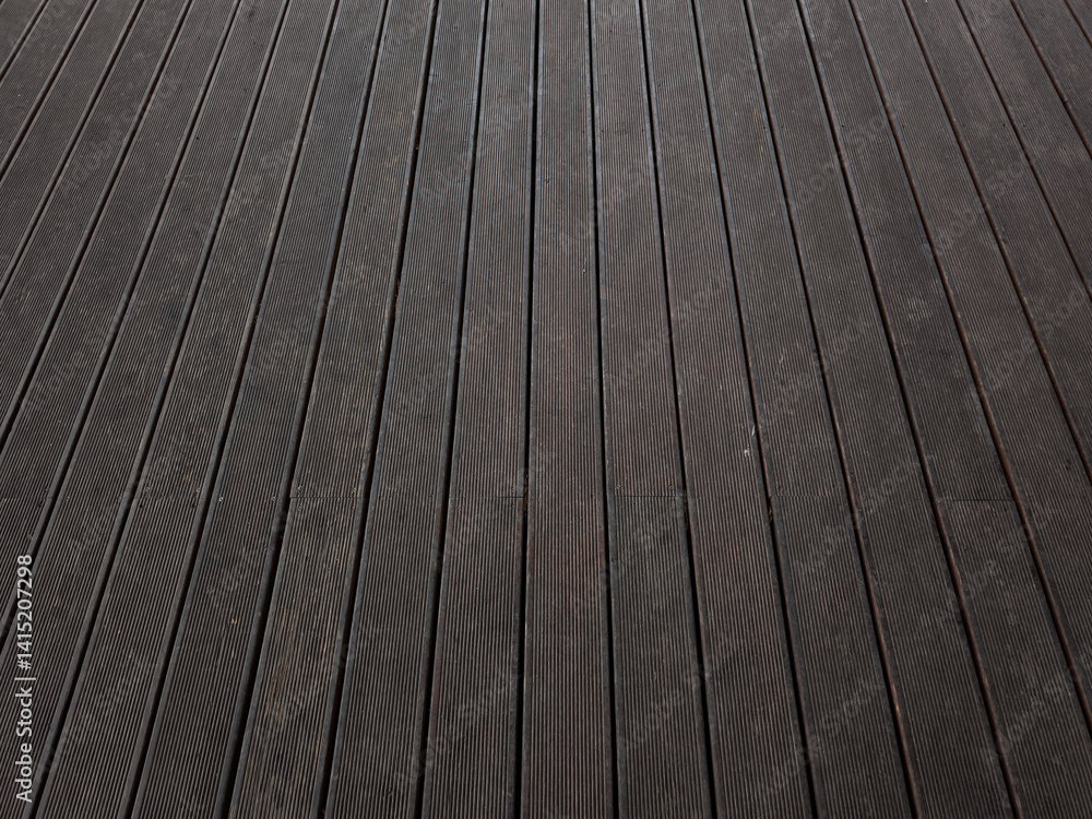 Dark wooden decking creating a textured and linear pattern copy space Dark wooden decking creating a textured and linear pattern copy space