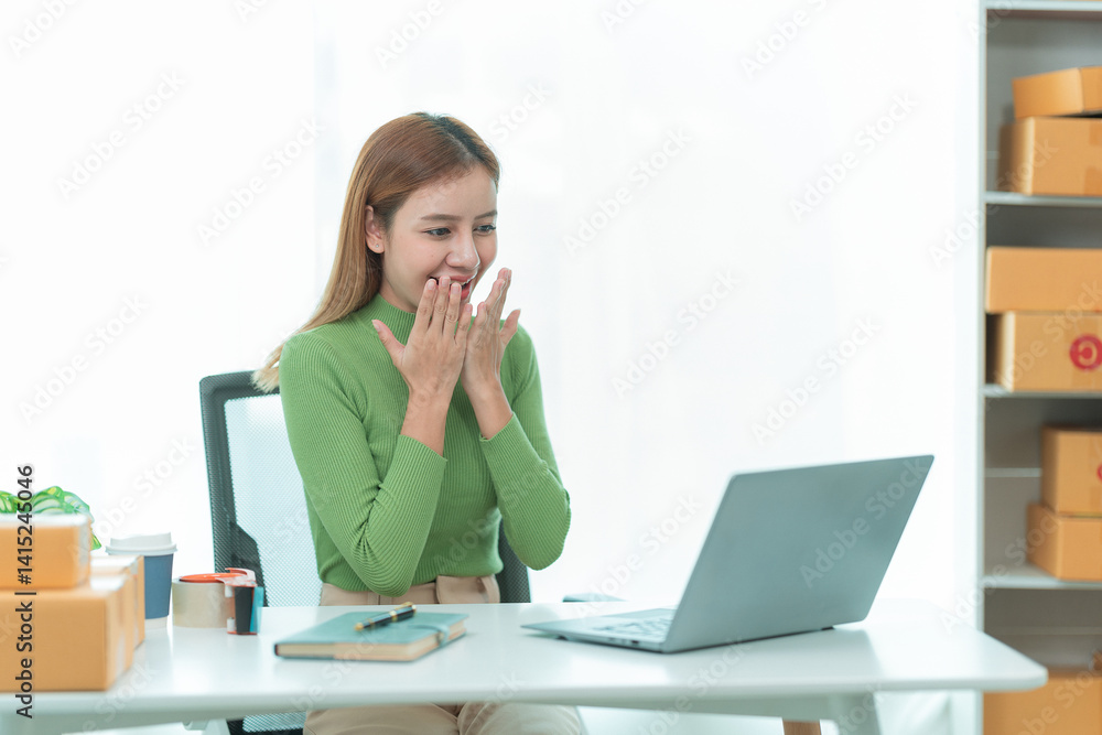 Asian woman she is excited and smiling to receive new order name size working with packaging box to write customer address in post box to send product sold online. Asian woman she is excited and smiling to receive new order name size working with packaging box to write customer address in post box to send product sold online.