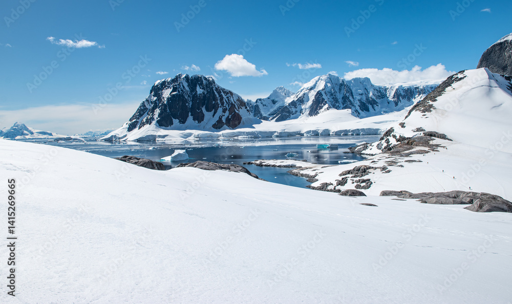 Travel Picture with Snow Landscape, Mountains and Bay of Water at Port Charcot in Antarctica