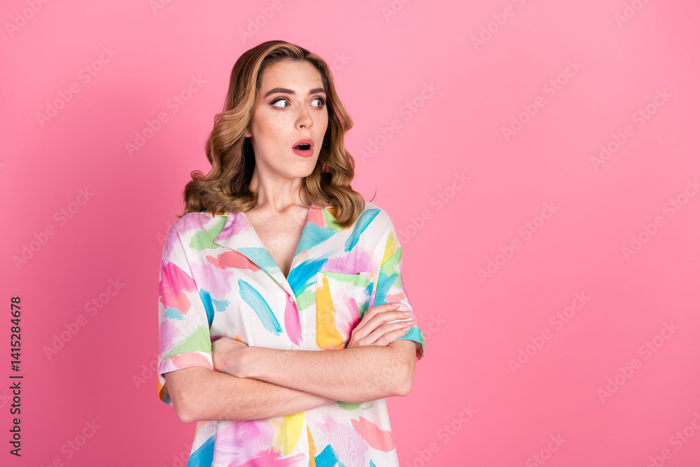 Young woman with surprised expression, colorful printed shirt and wavy hairstyle on pink background Young woman with surprised expression, colorful printed shirt and wavy hairstyle on pink background