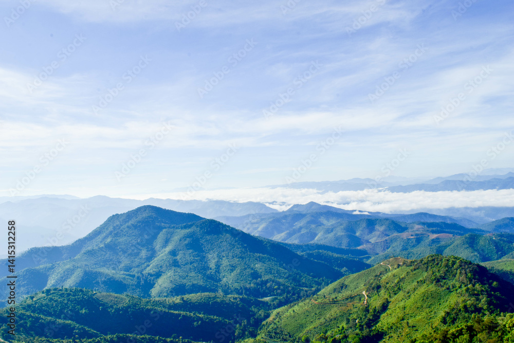 Fototapeta premium Scenic Mountain Landscape with Blue Sky and Layers of Misty Hills
