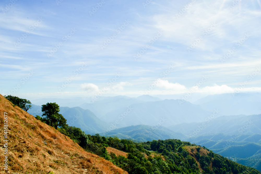 Fototapeta premium Scenic Mountain Landscape with Blue Sky and Layers of Misty Hills