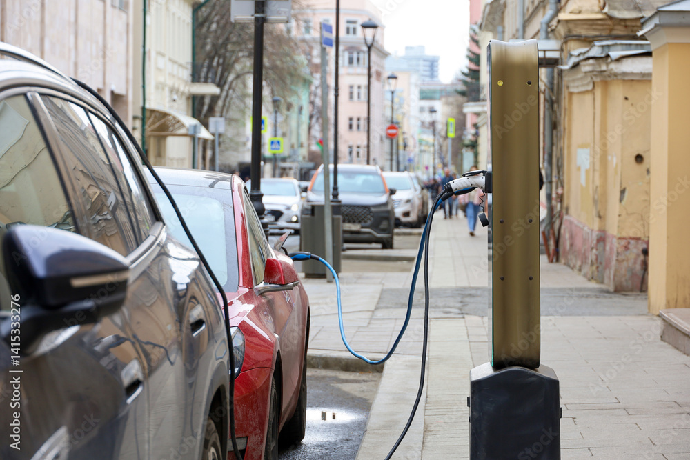 Electric car charging, eco-friendly transport. Charging station on a city street