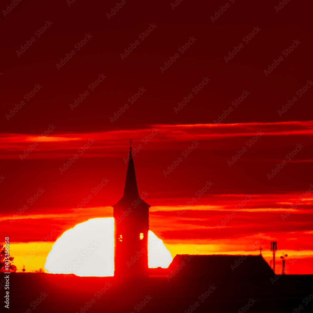 Megazoom (600mm) winter sunset or sundowner with a church silhouette near Haunersdorf, Otzing, Deggendorf, Bavaria, Germany