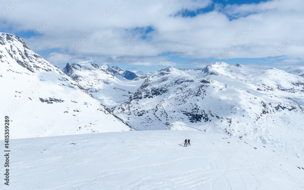 Alpine skiers on their way up to the top, and some skiers on their way down. Norwegian winter mountain landscape. Alpine skiers on their way up to the top, and some skiers on their way down. Norwegian winter mountain landscape.