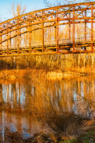 Obraz na płótnie Winter landscape with an old railway bridge and reflections on a sunny evening near Landau an der Isar, Dingolfing-Landau, Bavaria, Germany w salonie