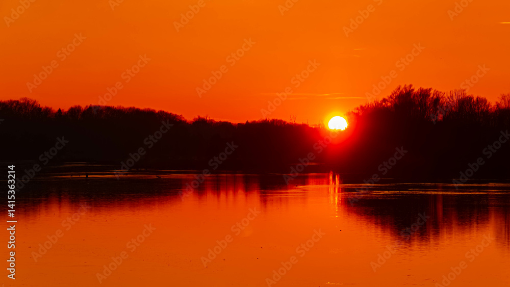 Winter sunset or sundowner view with reflections near Niederpoering, Isar, Oberpoering, Deggendorf, Bavaria, Germany Winter sunset or sundowner view with reflections near Niederpoering, Isar, Oberpoering, Deggendorf, Bavaria, Germany