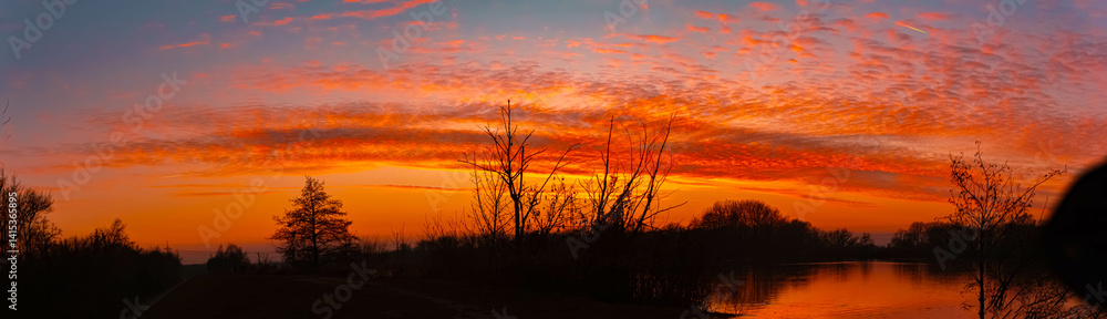 Fototapeta premium Sunset with reflections near Plattling, Isar, Bavaria, Germany