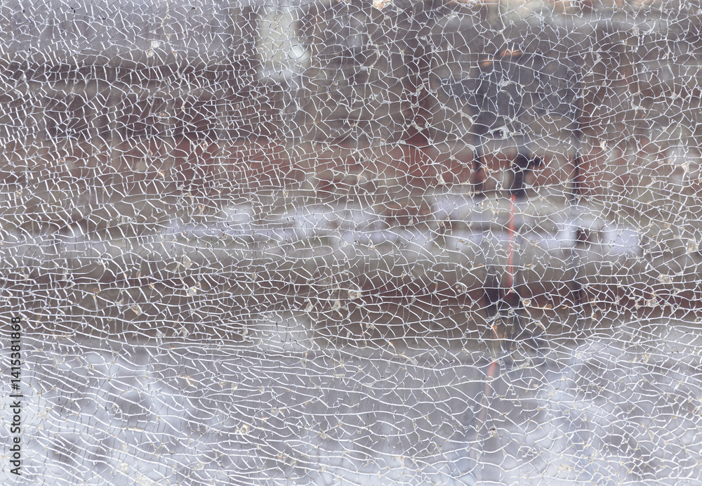 Texture of cracked broken glass cracked by impact. Detail of broken tempered glass pane too many small irregular shape pieces holding together, Cracks on the glass surface background, Space for text.