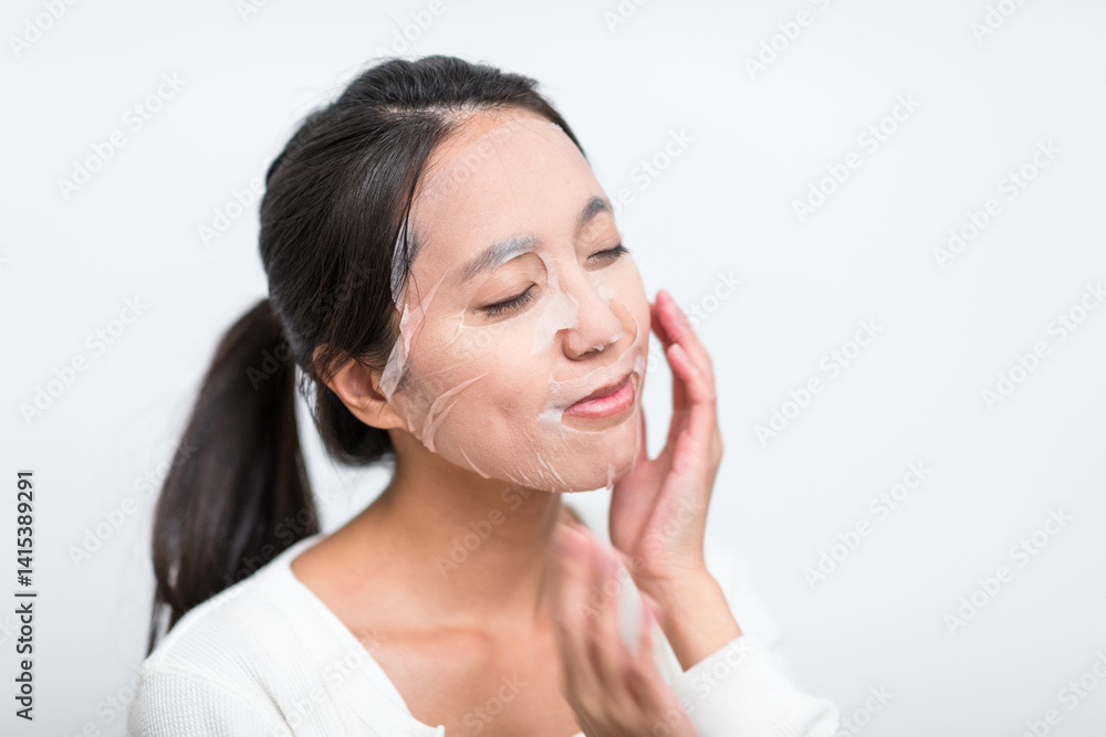 Woman applying skincare mask for facial glow