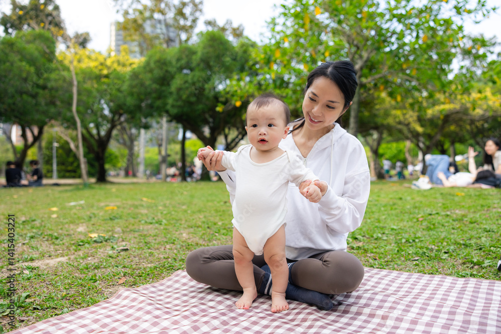 Mum and baby son enjoying picnic at park