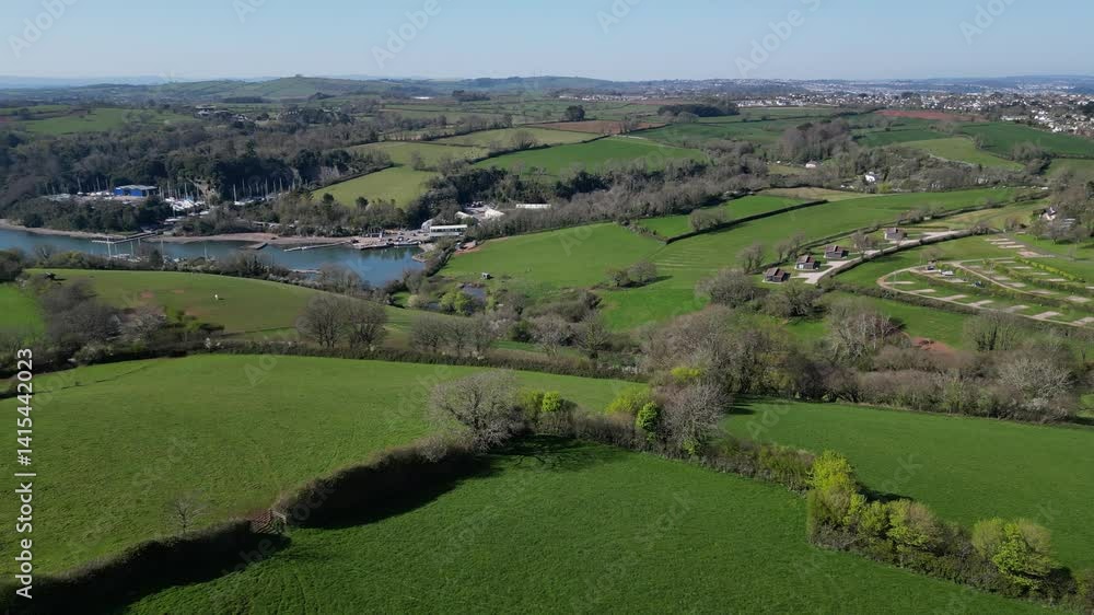 Churston, Torbay, South Devon, England: DRONE VIEWS: The drone flies towards Galmpton Creek marina on the River Dart. Torbay is a popular UK holiday destination and retirement area (Clip 2 of 5). Churston, Torbay, South Devon, England: DRONE VIEWS: The drone flies towards Galmpton Creek marina on the River Dart. Torbay is a popular UK holiday destination and retirement area (Clip 2 of 5).
